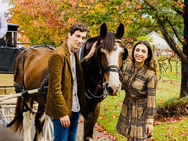 a couple posing beside a horse, Hunter Valley Classic Carriages