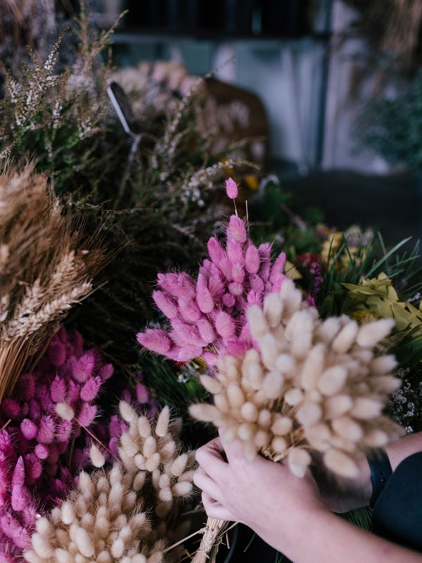 a hand picking flowers at Newcastle Food & Flower Markets