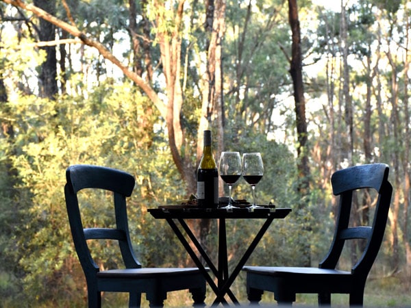 two wine glasses on the table at On Bell Glamping