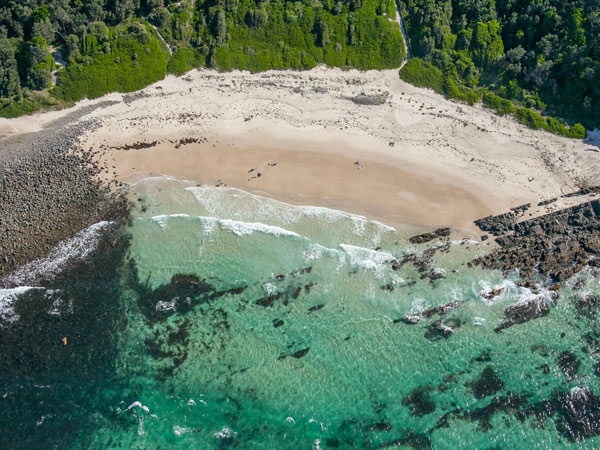 an aerial view of Pebbly Beach, Forster
