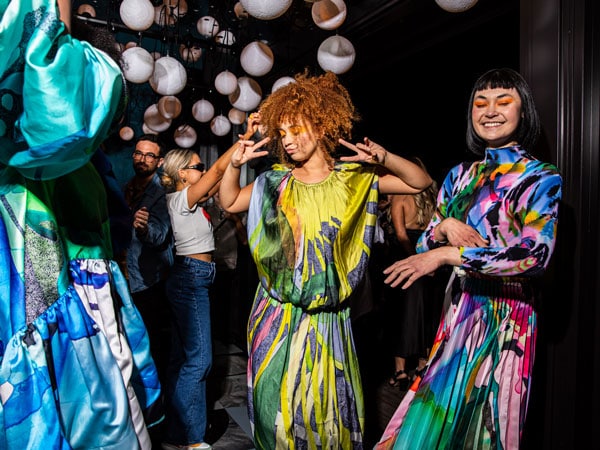 people with vibrant costumes dancing at Rooftop at QT Newcastle