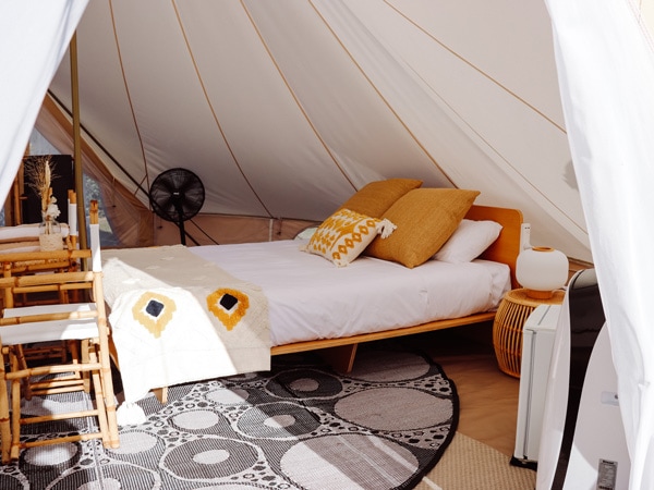 the bed inside a glamping tent at The Hideaway Cabarita Beach