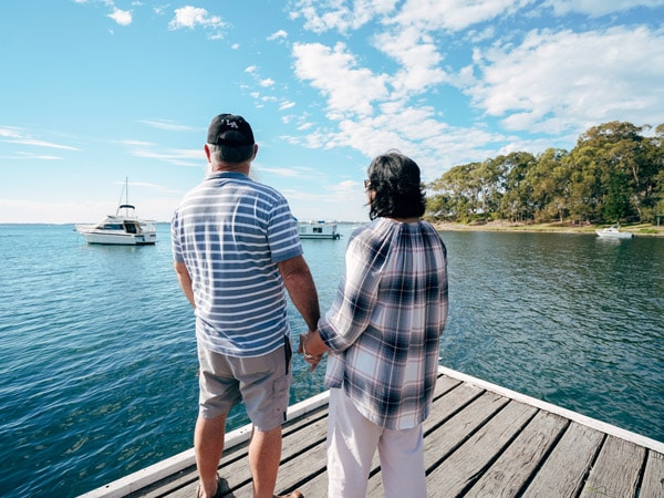 a couple holding hands on Lake Macquarie
