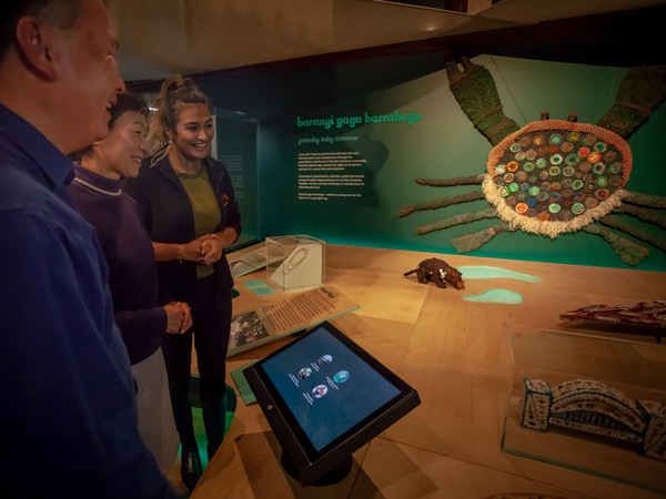 a group of visitors inside First Australians Gallery in the Australian Museum