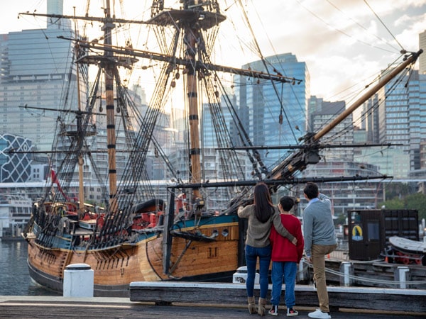 a family exploring the HMB Endeavour, an Australian-built replica of James Cook's ship on exhibit at the Australian National Maritime Museum, Darling Harbou