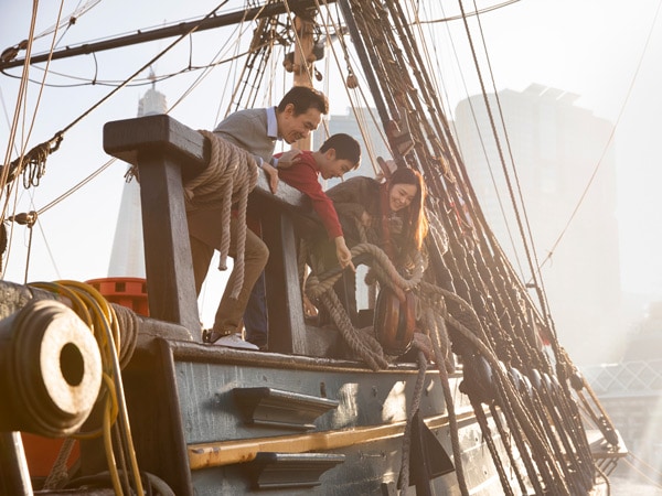 a family onboard an Australian-built replica of James Cook's ship at Australian National Maritime Museum