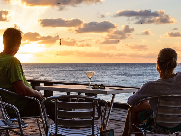 two people admiring the sunset at Baillie’s Bar, Heron Island, Qld