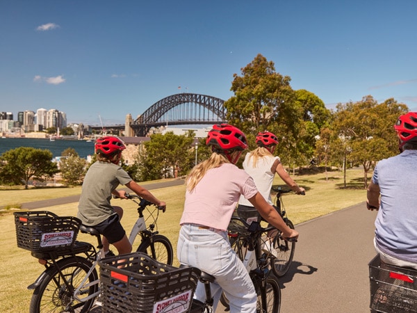 a family enjoying a ride through Barangaroo on their hired bicycles from Sydney Harbour Bike Tours