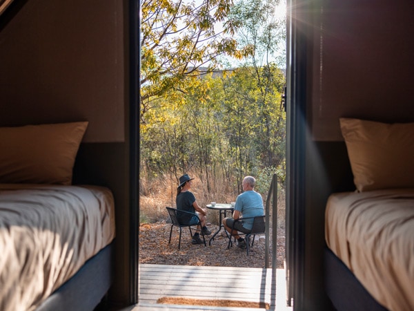 a couple sitting outside their tent at El Questro Wilderness Park, Gibb River Road accommodation