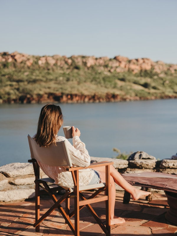 a woman sipping coffee at Faraway Bay
