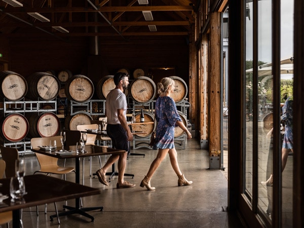 a couple walking out at the grand cellar door of Frogmore Creek