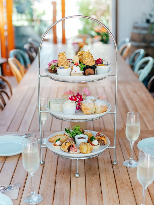 a three-tiered tray filled with sweets and pastries on the table at Heritage Gardens, Newcastle