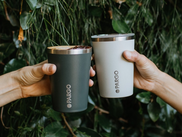 hands holding Project Pargo coffee cups, Christmas gift ideas