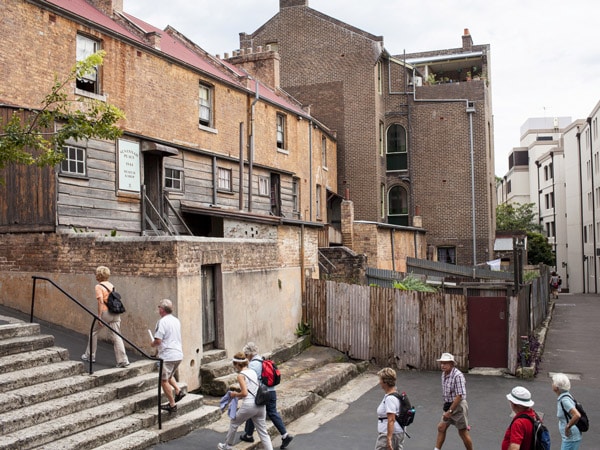 people heading upstairs towards the entrance of Susannah Place Museum