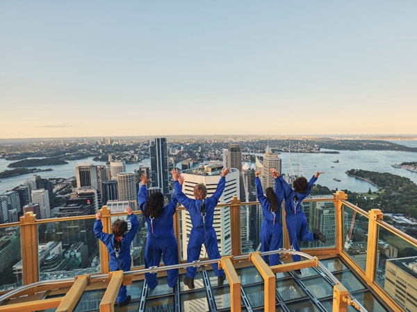 a family enjoying the Sydney Sky Tower Skywalk at sunset