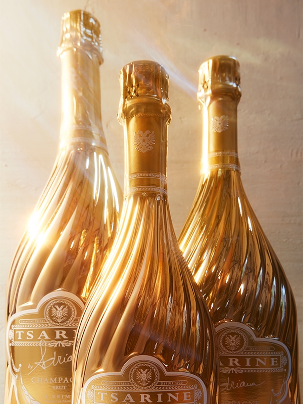 A golden bottle of Tsarine Champagne by Adriana