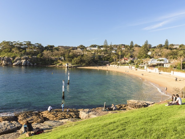 a couple relaxing at Green Point Reserve overlooking Camp Cove, Watsons Bay
