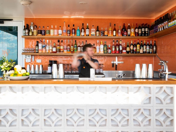 a bartender mixing drinks at Gigi Rooftop Bar, Thornbury