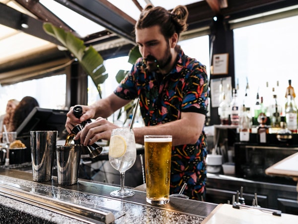 a bartender preparing drinks at Goldilocks Bar, CBD