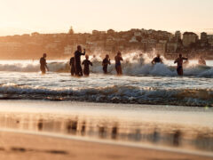 Locals run into the water at Bondi Beach