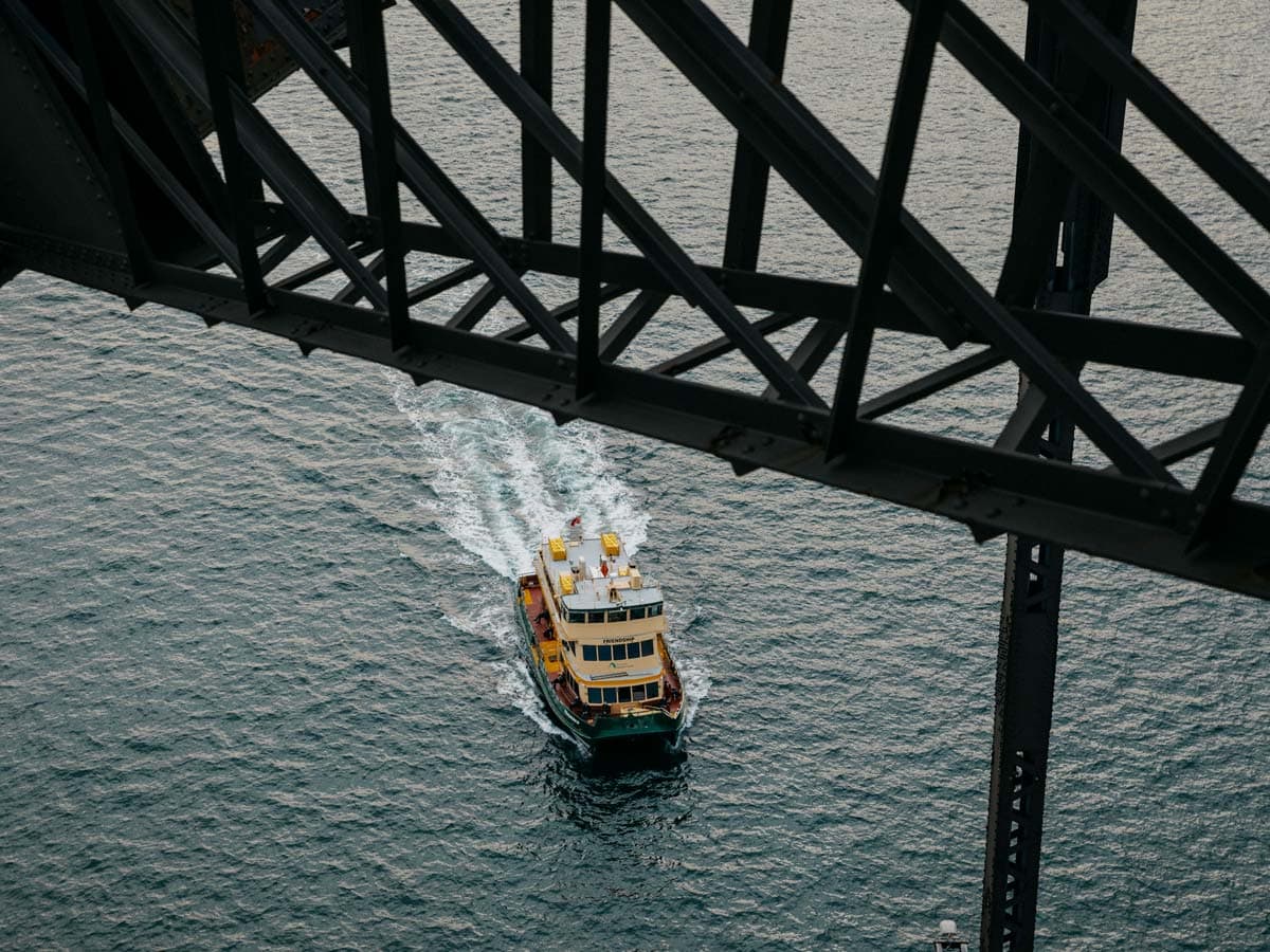 Sydney Ferry passes under the Sydney Harbour Bridge