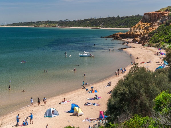 Beachgoers at Half Moon Bay in Melbourne