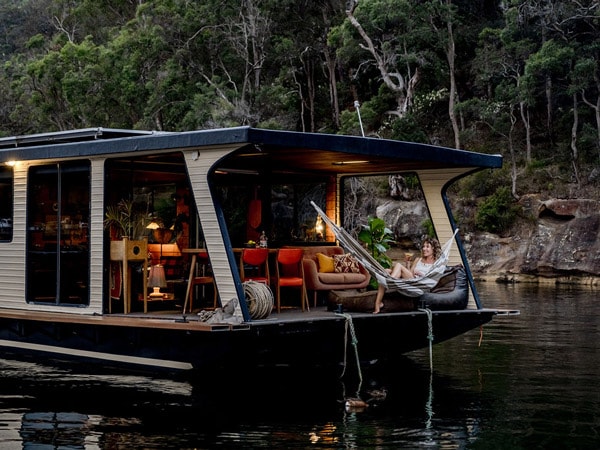 a woman resting on a hammock onboard Oh Buoy, Berowra Waters, NSW