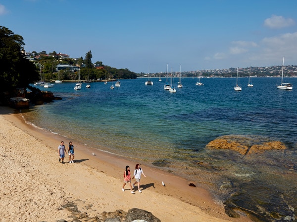 friends enjoying a walk along Milk Beach on the Hermitage Foreshore Track, Vaucluse in Sydney