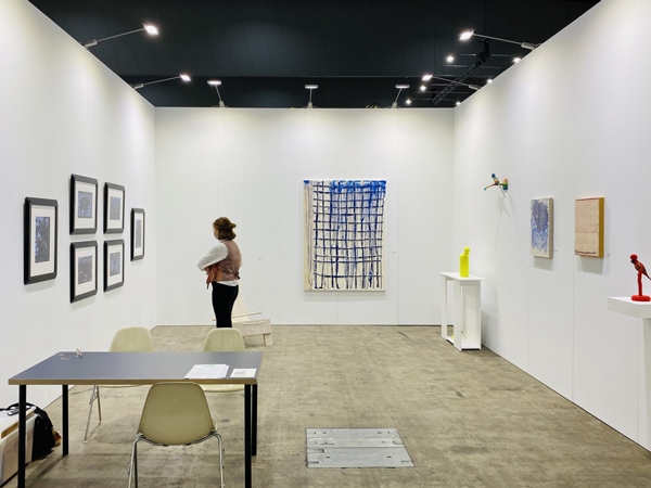 a woman looking at Kushana Bush exhibition in Darren Knight Gallery