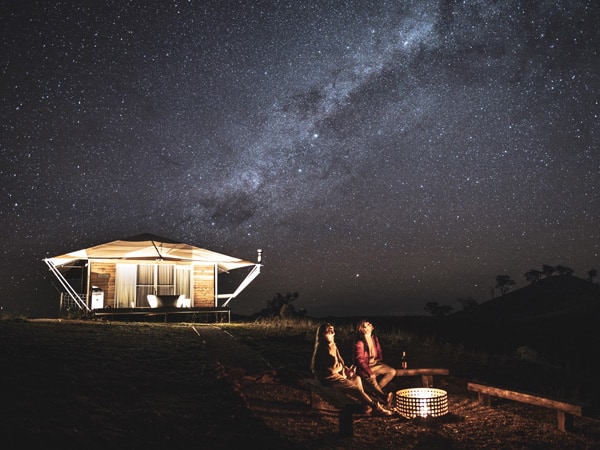 Couple enjoying the firepit while stargazing from the DulliTent at Sierra Escape, Piambong.