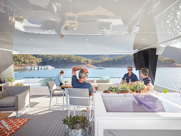 guests resting inside The Edge houseboat on Lake Eildon, Victoria’s High Country