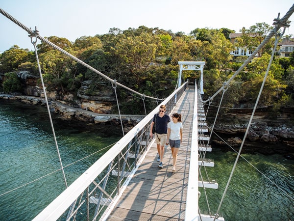 a couple walking on a bridge over Parsley Bay, Vaucluse