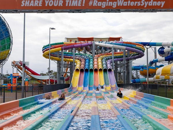 people enjoying the huge water slide at Raging Waters, Sydney