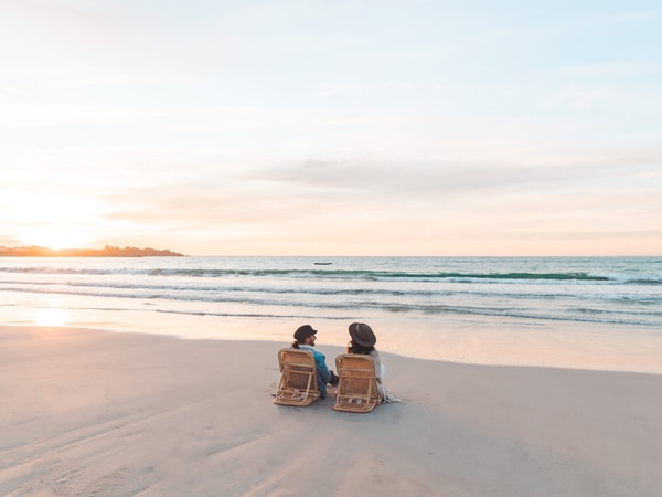 two people sitting on a sun lounger by the beach at Robe, SA