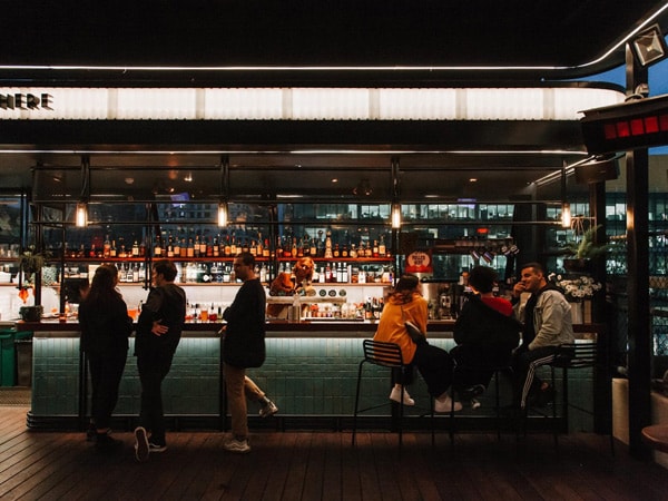 folks enjoying late night drinks at Rooftop Bar, CBD