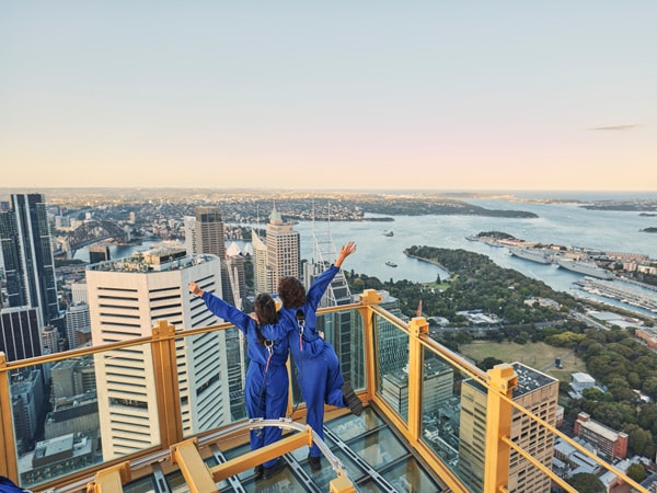 two people posing at Sydney Sky Tower Skywalk at sunset