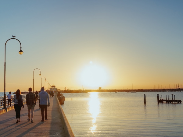 people walking along St Kilda pier at sunset, Melbourne, VIC