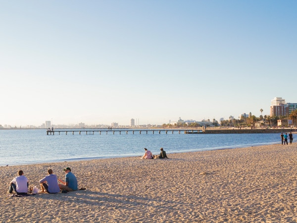 people sitting by the seaside at St Kilda Beach, Melbourne, VIC