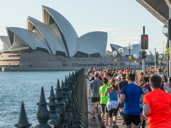 Sydney Marathon participants running with views of the Sydney Opera House
