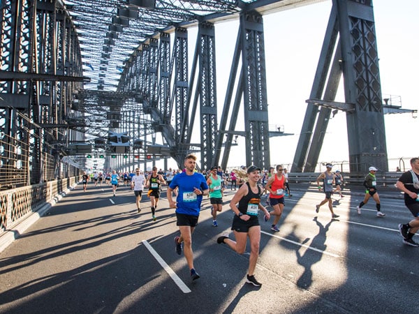 participants run across the Sydney Harbour Bridge during the Sydney Marathon