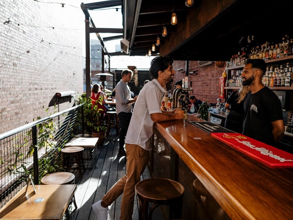 a man ordering drinks at Union Electric Bar, CBD