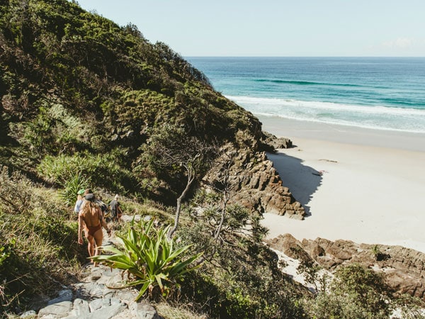 friends strolling around Whites Beach in Byron Bay