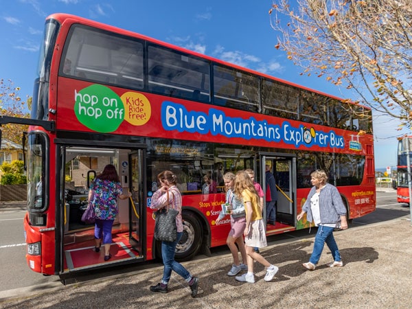 a family hopping on the Blue Mountains Explorer Bus, Katoomba