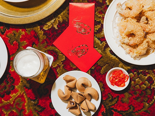Lucky red envelopes and fortune cookies laid out on an ornate tablecloth at the Bob Hawke Beer and Leisure Centre in Marrickville Sydney.