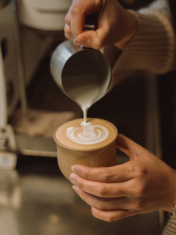 pouring milk over coffee at Chiaki, Collingwood