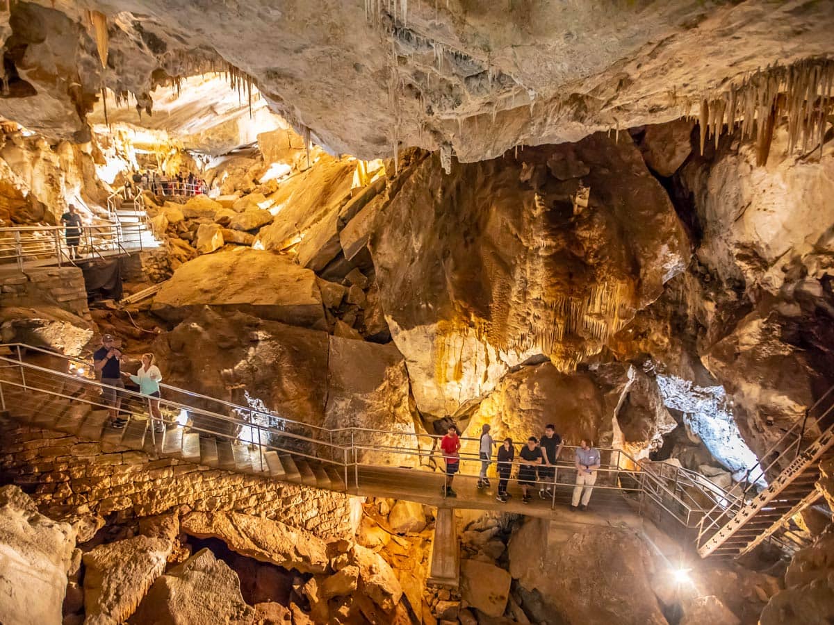A group of people tour the intricate Jenolan Caves