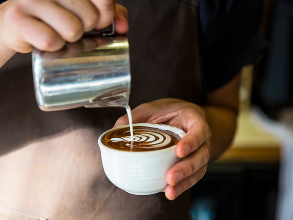 pouring milk over coffee at Industry Beans, Fitzroy