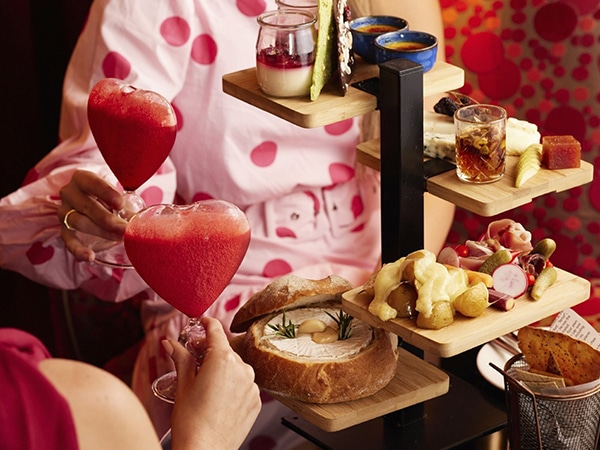 Heart-shaped cocktails and a three-tiered tray of savoury and sweet cheese dishes.