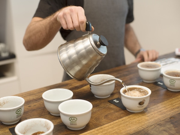 a barista preparing coffee at Market Lane Coffee, Prahran