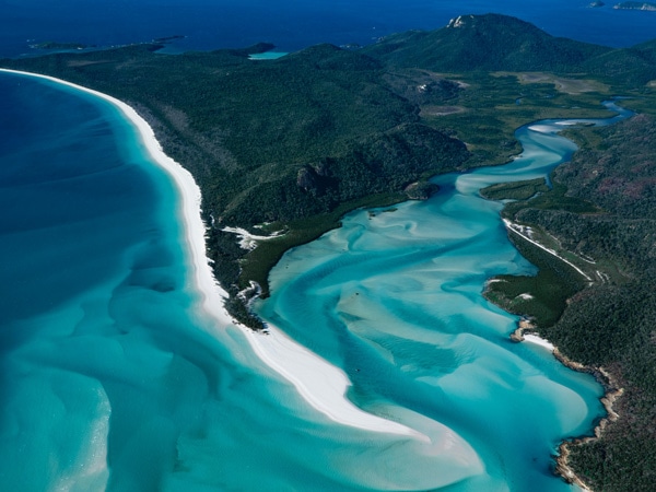 an aerial view of the swirling sands and clear turquoise waters in Whitehaven Beach